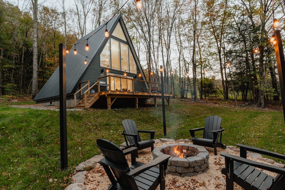 glamping guests sitting around fire pit evening
