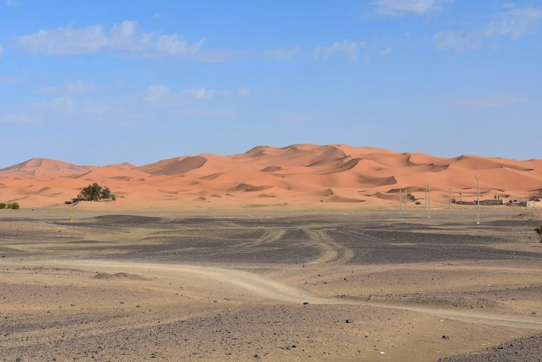 White canvas desert camp tents at the base of the Erg Chebbi dunes near Merzouga, Morocco
